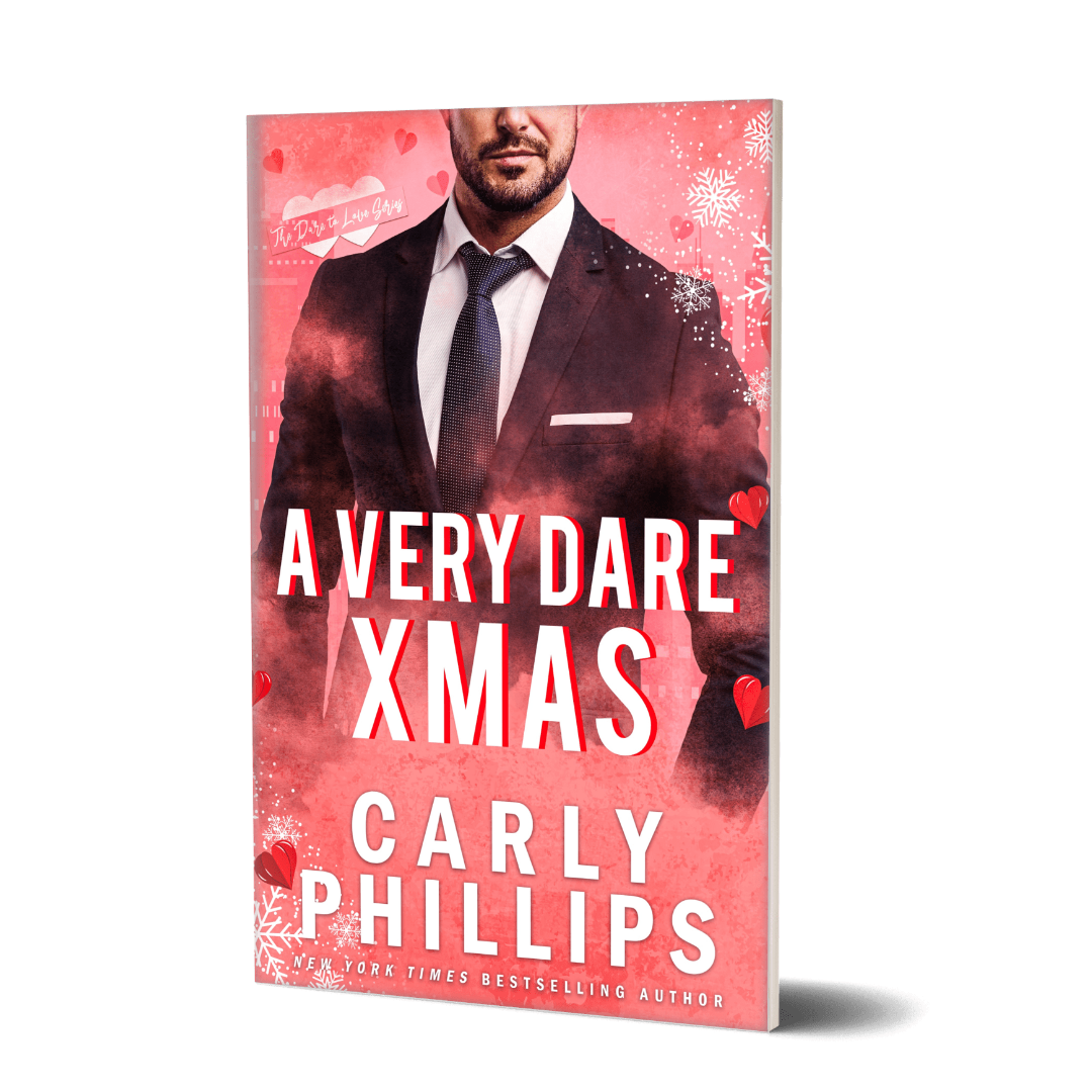A Very Dare Christmas paperback cover, featuring a rosy background with hearts and snowflakes and featuring a handsome hero in a suit and tie.