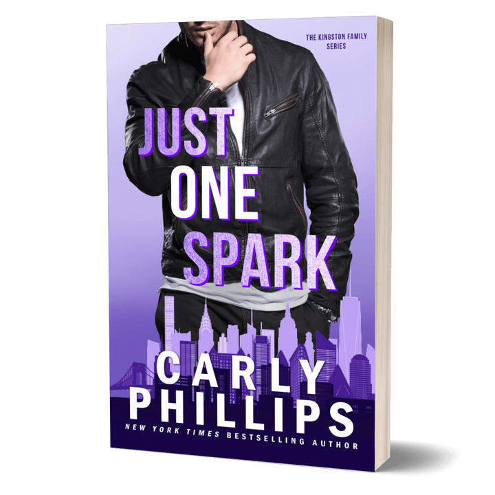 Book cover of 'Just One Spark' by Carly Phillips with a man in a leather jacket on a purple background.